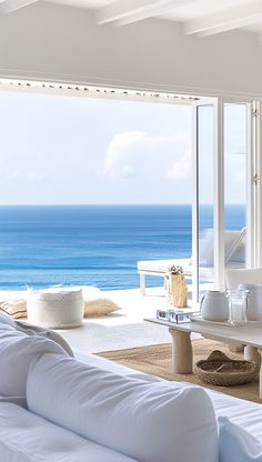 a living room filled with furniture and an ocean view