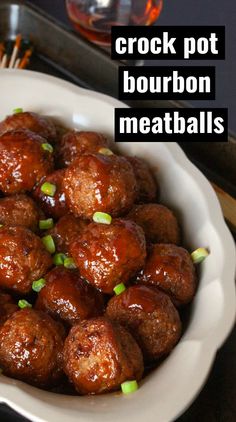 a white bowl filled with meatballs on top of a wooden table next to chopsticks