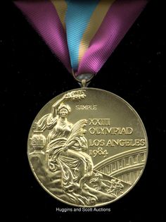 a gold medal with a purple ribbon around it