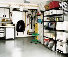 a garage filled with lots of storage and hanging items on the wall next to it