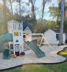 there is a play area in the backyard with a slide and climbing frame for children