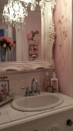 a white bathroom sink sitting under a mirror