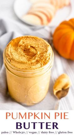 pumpkin pie butter in a glass jar next to sliced pumpkins