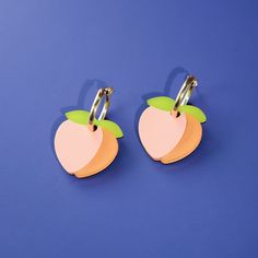 Who doesn't love peaches? Our Peach earrings are a cute and lovely addition to our Fruit Salad collection!  Charm measures 1. 5" x 1" (38mm x 26mm) The pair weighs 8 grams total—that's just a touch more than a quarter or euro coin!  Gold-filled hoop is tarnish resistant and hypoallergenic, keeping sensitive ears comfortable. Hand-made in the By Chavelli studio in NYC. Keep away from extreme heat and wipe clean with water or makeup remover Pink Fruit Design Earrings, Playful Pink Hoop Earrings Gift, Trendy Pink Fruit Design Earrings, Pink Small Hoop Earrings In Cute Style, Cute Small Hoop Pink Earrings, Cute Small Pink Hoop Earrings, Pink Playful Handmade Hoop Earrings, Peach Earrings, August Birthstone Jewelry