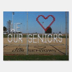 the words we love our seniors are written in white letters on a fence