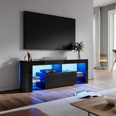 a living room with a large television on the wall