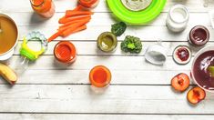 an assortment of foodstuffs and sauces laid out on a white wooden table