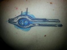 a tattoo on the back of a man's shoulder with a sci - fi design