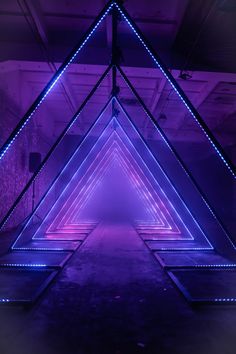 an art installation with neon lights in the shape of triangulars and rectangles