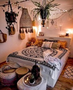 a bed room with a neatly made bed and lots of hanging plants on the wall