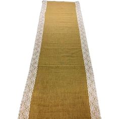 a long table runner with white lace on the edge and gold trimming around it