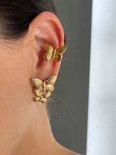 Elevate your style with The Butterfly Earcuff! Crafted from durable stainless steel and gold plating, this unique earcuff features a delicate butterfly shape that adds a touch of whimsy to any outfit. Make a bold statement and stand out from the crowd with this must-have accessory. Trendy Yellow Gold Ear Cuff, Trendy Gold Plated Ear Cuff, Spring Gold Jewelry With Butterfly Charm, Elegant Spring Butterfly Jewelry, Gold Plated Ear Cuff, Trendy Yellow Gold Ear Cuff As Gift, Trendy Yellow Gold Ear Cuff For Gift, Elegant Spring Jewelry With Butterfly Charm, Trendy Clip-on Ear Cuff As Gift