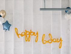 balloons that say happy baby are hanging on the wall next to it's name