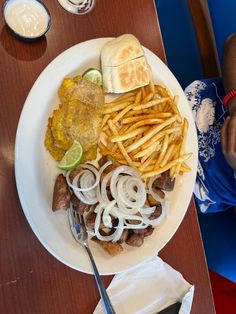 a white plate topped with fries and onions