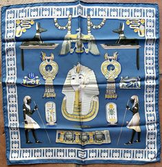 Hermès commissioned Vladimir Rybaltchenko to design the Tutankhamun scarf in 1976, just as the groundbreaking Tuthankhamun archaeological exhibition was making the rounds of the world’s greatest museums. Here, as a pochette scarf from a later issue, in an exquisite blue colorway with pops of rich yellows and greens. Care tag attached. An important design for any Hermès scarf collection. Hermes Silk Scarf, Blue Silk Scarf, Hermes Silk, Tutankhamun, Hermes Scarf, Blue Silk, Luxury Vintage, Silk Scarves, Silk Scarf