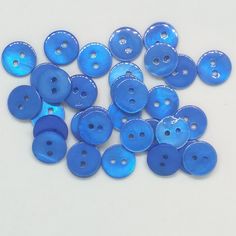 many blue buttons on a white surface