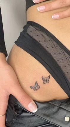 a pregnant woman's belly with butterflies on her stomach and the bottom part of her tummy