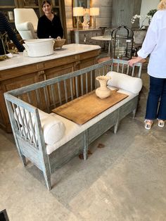 two women are standing in the kitchen with their chairs and counter tops made out of wood