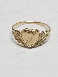 "Thanks for shopping our vintage estate store. We tend to sell well below wholesale and truly hope you enjoy all of our items. Many of the items are one of a kind, so please enjoy scrolling through the pictures and hopefully something will catch your eye. Brown spots are from camera or reflections. Estate 14k yellow gold monogram cursive capital J heart ring. Custom made ring for our shop. Ring size: 3 Setting: 7.5mm 1/4\" to 3/8\" Band width: 1.4mm Weight: .97 gram Marked 14k and it's sweet. On Heirloom 14k Gold Jewelry For Valentine's Day, Heirloom Engraved Heart Ring, Valentine's Day Heirloom 14k Gold Jewelry, Classic Engraved Heart Promise Ring, Victorian 14k Gold Jewelry For Valentine's Day, Victorian Gold Initial Ring As Gift, Vintage Yellow Gold Ring With Engraving Option, Vintage Engraved Heart Ring For Wedding, Antique Personalized Yellow Gold Signet Ring