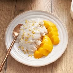 a white plate topped with rice and mango slices