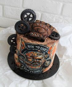 a motorcycle themed cake with wheels on top