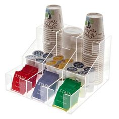 a stack of plastic cups sitting on top of each other in a holder with dividers