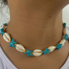 🐚 Embrace Bohemian Elegance! Introducing our Beige Adjustable Cowrie Shell with Turquoise Starfish Choker, a unique and stylish piece meticulously handcrafted to bring a touch of bohemian elegance to your style! This necklace is a true reflection of a love for the beach, symbolizing adventure, freedom, and a deep connection with nature. 🌊 Inspired by the Beauty of the Ocean: Crafted with a passion for the serene beauty of the ocean and the elegance of natural elements, this necklace is a celebration of adventure, tranquility, and the timeless beauty of nature. It's a versatile accessory for those who appreciate chic elegance and the calming ambiance of the beach. 🌟 Unique & Trendy Design: With its distinctive cowrie shell, turquoise starfish, and adjustable design, this choker is a tren Bohemian Starfish Jewelry For Vacation, Starfish Jewelry For Vacation, Bohemian Summer Jewelry In Ocean Color, Summer Bohemian Blue Jewelry, Summer Bohemian Ocean Color Jewelry, Summer Bohemian Style Blue Jewelry, Bohemian Starfish-shaped Turquoise Jewelry, Bohemian Turquoise Starfish Jewelry, Bohemian Starfish Jewelry For Beach Season