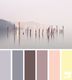 an image of a foggy lake with wooden posts in the water