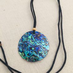 This beautiful necklace feature a large-2 inch round Abalone shell (New Zealand Paua shell ) Pendant .The iridescence of these Paua Abalone is truly amazing .Depending on the angle of the light source they will radiate colors from greens and pinks to purples and blues. The shells are then polished to a high gloss to reveal the beauty of their natural pattern. The pendant is held by an attractive black satin cord that is adjustable for your perfect fit. DETAILS - Shell Types : Paua Abalone Shell Paua Shell Necklace, Abalone Shell Necklace, Abalone Jewelry, Island Jewelry, Hawaiian Jewelry, Cord Jewelry, Paua Shell, Cute Gift Boxes, Abalone Shell