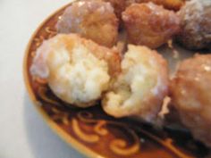 a plate full of doughnuts sitting on top of a white tablecloth covered table