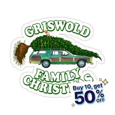 a car with a christmas tree on the roof is parked next to a 50 % off sale sign