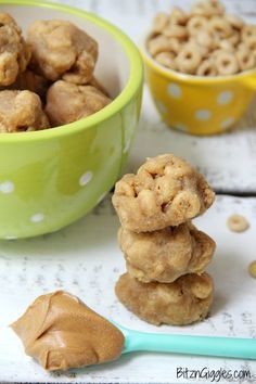 there are some peanut butter cookies stacked on top of each other in front of the bowl