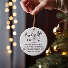 someone holding a christmas ornament that says, his light remains there are some who bring a light so great to the world