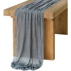 a wooden bench with a gray scarf hanging from it's back end, on a white background