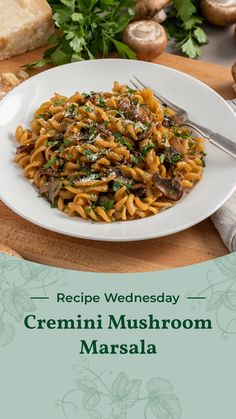 a plate of pasta with mushrooms and parsley on the side, next to bread