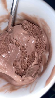 a bowl filled with chocolate ice cream on top of a table