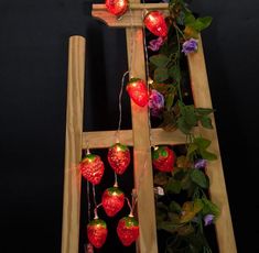 a ladder decorated with lights and strawberries