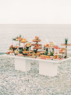 an outdoor buffet is set up on the beach for guests to enjoy their meal and drink