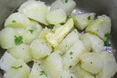 potatoes and parsley are being cooked in a pan