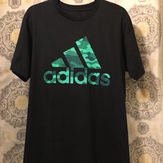 Adidas Tee Shirt Adidas Camo Logo New And Never Used Adidas Green Sports T-shirt, Adidas Green T-shirt For Sports, Adidas Green Short Sleeve T-shirt, Adidas Green T-shirt For Streetwear, Casual Green Adidas T-shirt, Adidas Green Cotton T-shirt, Adidas Crew Neck Shirt With Letter Print, Green Adidas Cotton T-shirt, Adidas Sporty Shirt With Letter Print