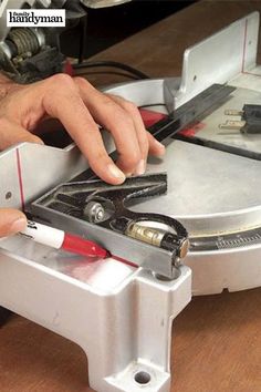 a man is working on some kind of device with scissors and wires attached to it