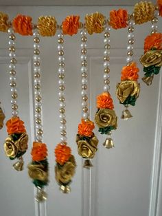 an assortment of beads and flowers hanging from a door