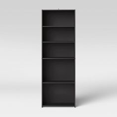 an empty black bookcase on a white background with no one in the room to see it