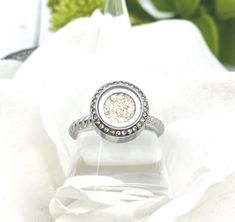 This ring is such a wonderful and beautiful keepsake to commemorate any loved one or any beloved pet. It is made from stainless steel so it is considered hypoallergenic and will not tarnish or turn your fingers green. The circle on this ring measures approximately 13mm the band is a sturdy twisted/rope style. This ring can be filled with human or pet cremation ashes, sand, small flower petal pieces, glitter, hair, fur, etc. by removing the small screw on the side of the ring. A small drop of sup