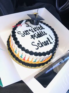 a decorated cake sitting on top of a white box