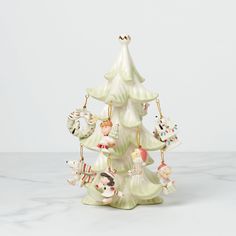 a ceramic christmas tree with ornaments on it