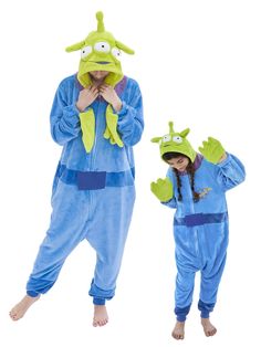 two people in pajamas are standing next to each other and one is wearing a frog costume