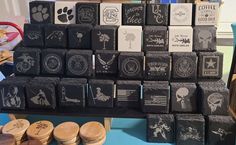 several rubber stamps are stacked on top of each other in front of a blue table