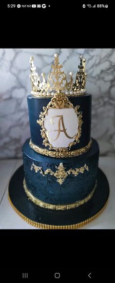 a three tiered blue cake with gold trimmings and a crown on top