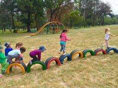 children playing in the park with giant tires